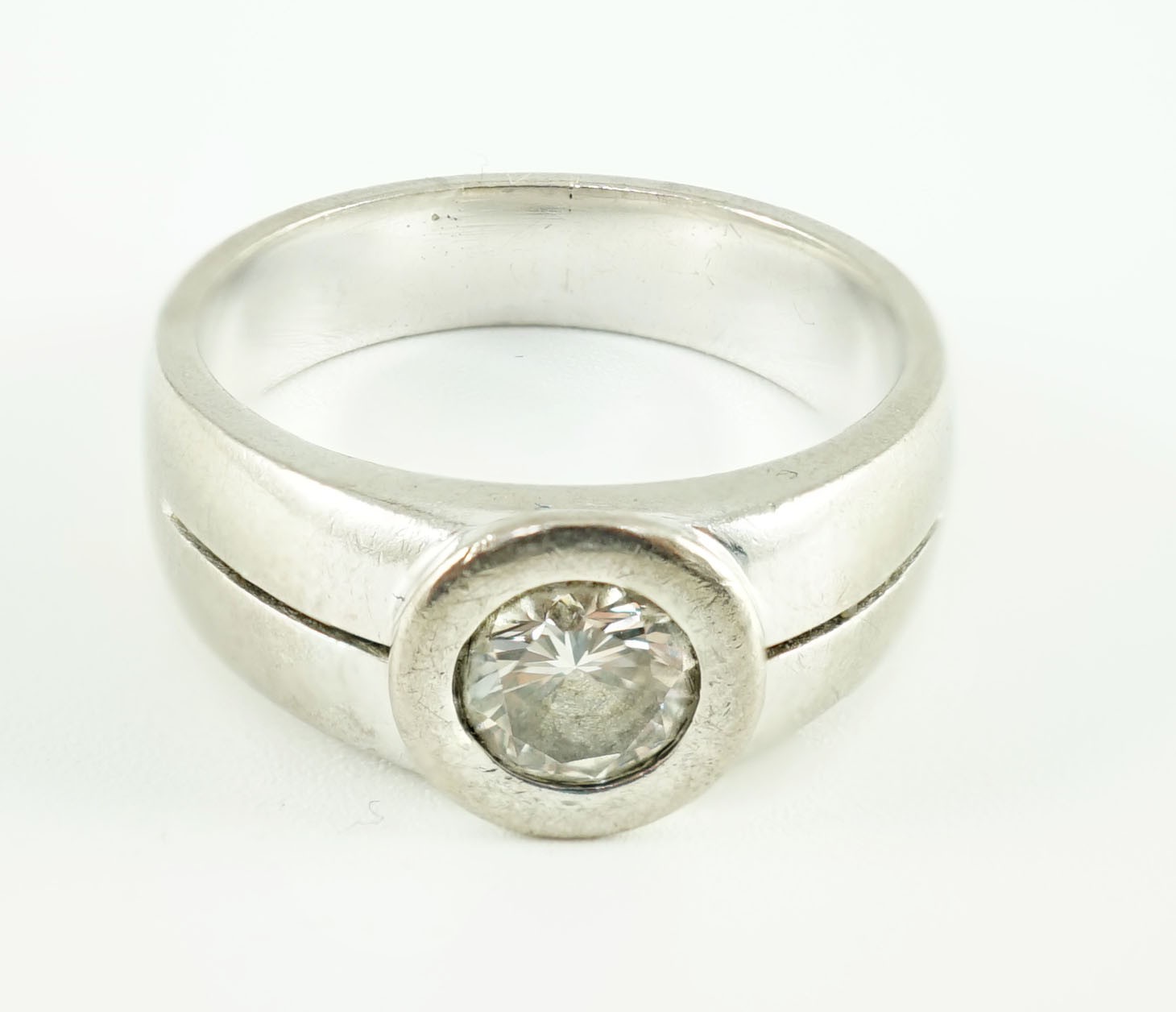 A modern 18k white gold and collet set solitaire diamond ring